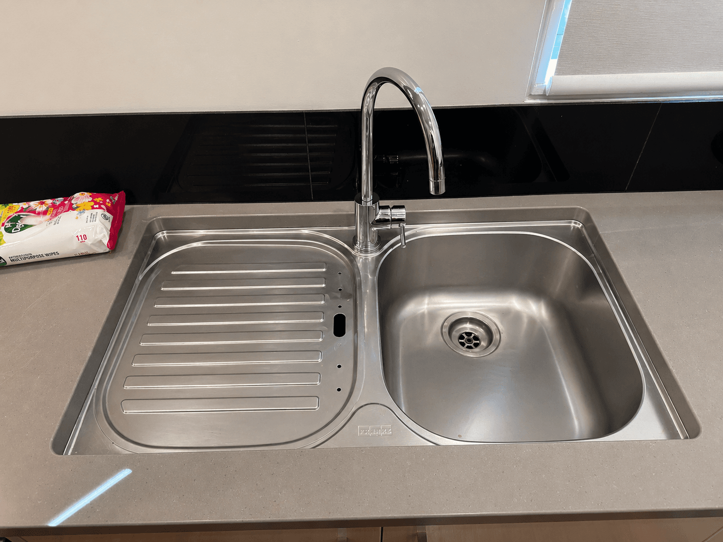 Clean kitchen sink and benchtop after detailed cleaning